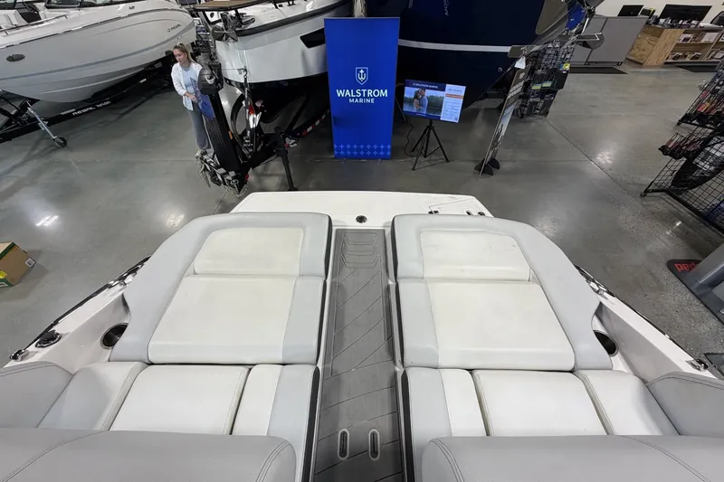 Slide: The Image of 2015 Regal 2300 Bowrider boat interior at showroom, featuring spacious seating and modern design. - 14