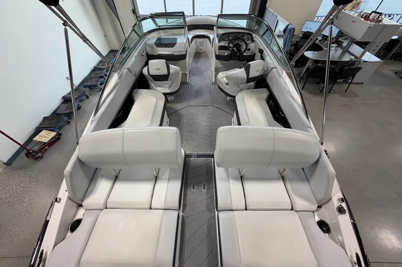 Slide: The Image of 2015 Regal 2300 Bowrider boat interior with white seating and modern dashboard. - 13
