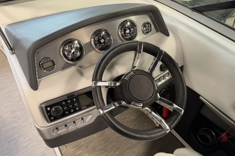 Slide: The Image of Dashboard of 2015 Regal 2300 Bowrider with steering wheel and control panel. - 23