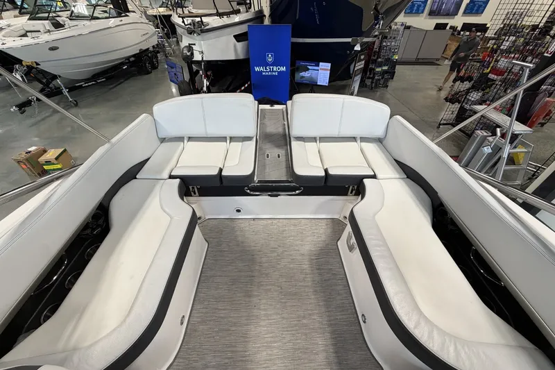 Slide: The Image of 2015 Regal 2300 Bowrider interior with white seating in showroom setting. - 15