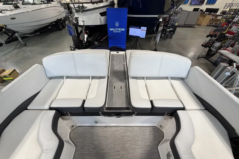 Slide: The Image of 2015 Regal 2300 Bowrider interior with white seating in showroom. - 16