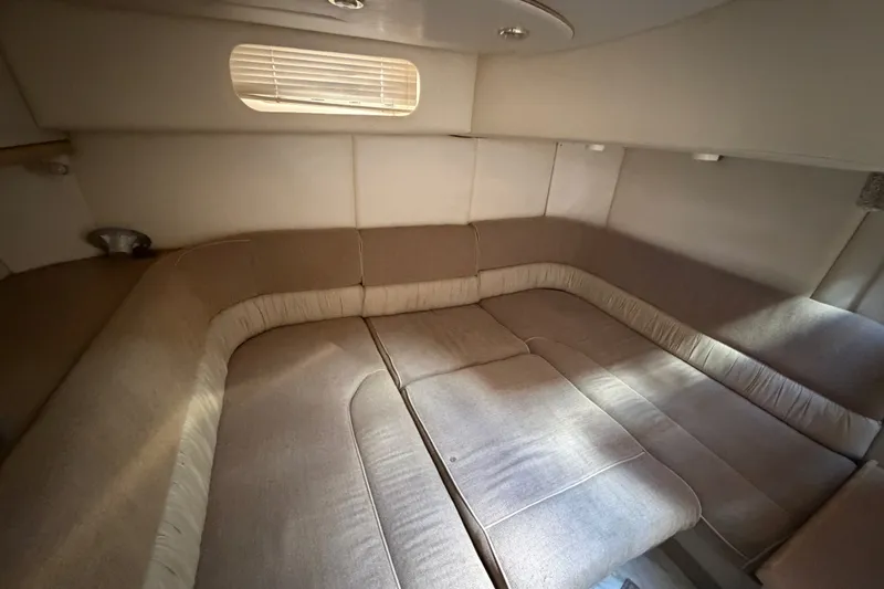 Slide: The Image of 1997 Maxum 4100 SCR cabin interior with beige upholstery and window blinds. - 7
