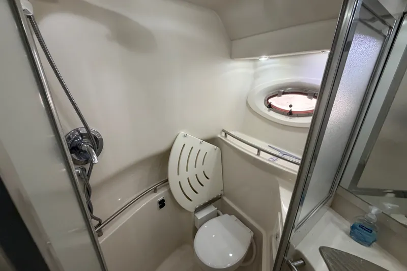 Slide: The Image of Bathroom interior of 1997 Maxum 4100 SCR yacht with shower and porthole. - 12