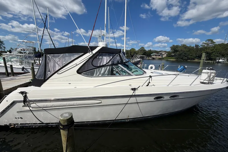 Slide: The Image of 1997 Maxum 4100 SCR yacht docked at marina under blue sky. - 3