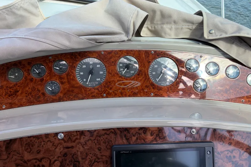 Slide: The Image of Dashboard of a 1997 Maxum 4100 SCR boat with gauges and controls. - 28