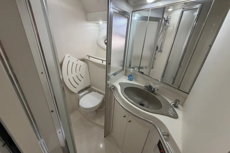 Slide: The Image of Bathroom interior of 1997 Maxum 4100 SCR yacht with sink and toilet. - 13