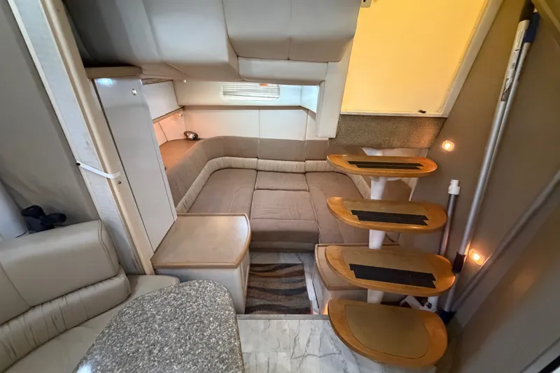 Slide: The Image of Interior of 1997 Maxum 4100 SCR yacht with cozy seating and wooden steps. - 16