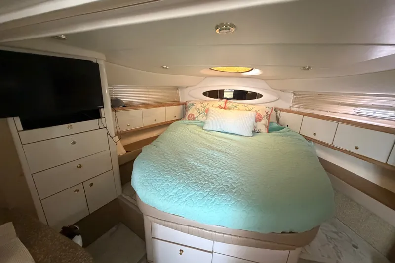 Slide: The Image of Luxurious 1997 Maxum 4100 SCR yacht cabin with cozy bed and modern amenities. - 14