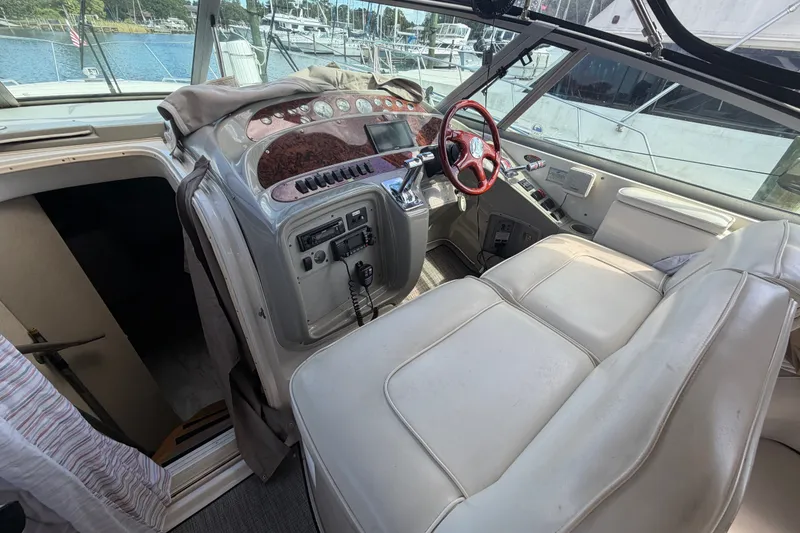 Slide: The Image of 1997 Maxum 4100 SCR yacht cockpit with red steering wheel and control panel. - 25