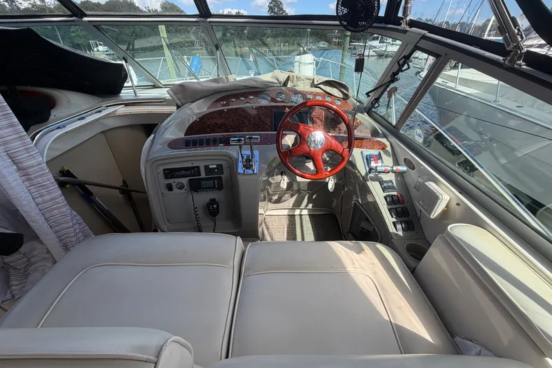 Slide: The Image of 1997 Maxum 4100 SCR boat cockpit with wooden steering wheel and control panel. - 23