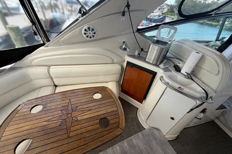 Slide: The Image of Luxurious interior of 1997 Maxum 4100 SCR yacht with wooden table and kitchenette. - 32