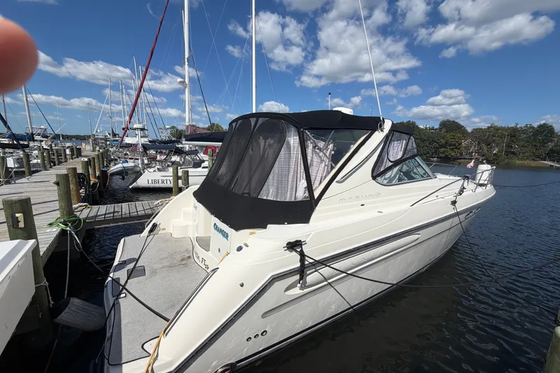 Slide: The Image of 1997 Maxum 4100 SCR yacht docked at marina under blue sky. - 2