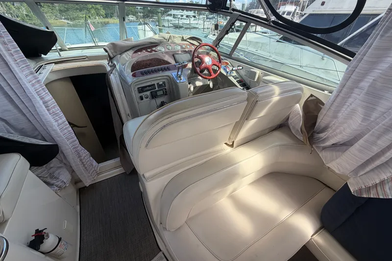 Slide: The Image of Interior of 1997 Maxum 4100 SCR yacht with helm and seating area. - 24