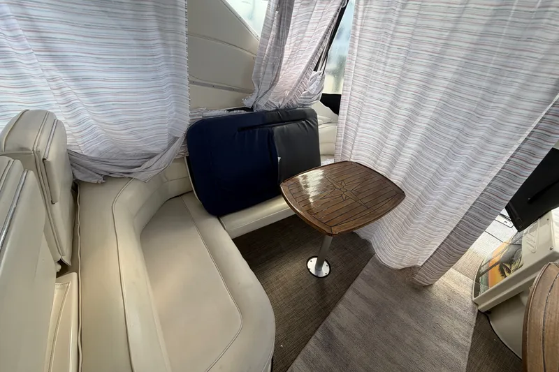 Slide: The Image of Interior of 1997 Maxum 4100 SCR yacht with seating and wooden table. - 33