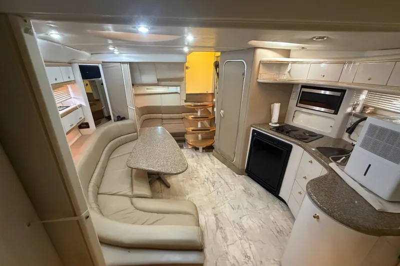 Slide: The Image of Luxurious interior of a 1997 Maxum 4100 SCR yacht with modern kitchen and seating area. - 19