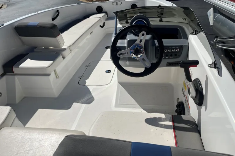 Slide: The Image of Interior of a 2022 Tahoe T18 boat, featuring steering wheel and seating. - 3