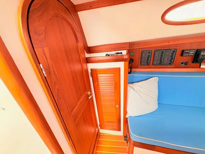 Slide: The Image of Interior of a 2009 Alerion Express 38 with wooden doors and blue upholstery. - 12