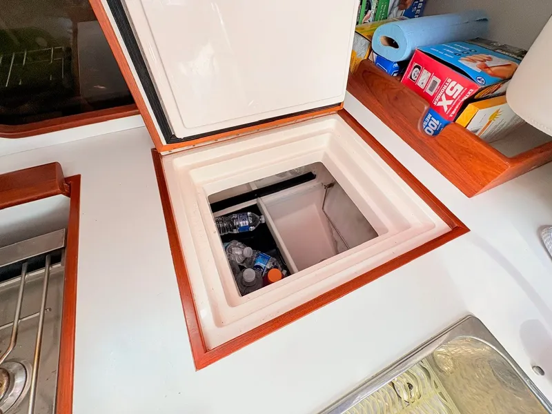Slide: The Image of An open cooler compartment on a boat with drinks and supplies. - 15
