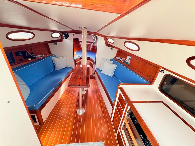 Slide: The Image of Interior of a 2009 Alerion Express 38 with wooden floors and blue upholstery. - 6