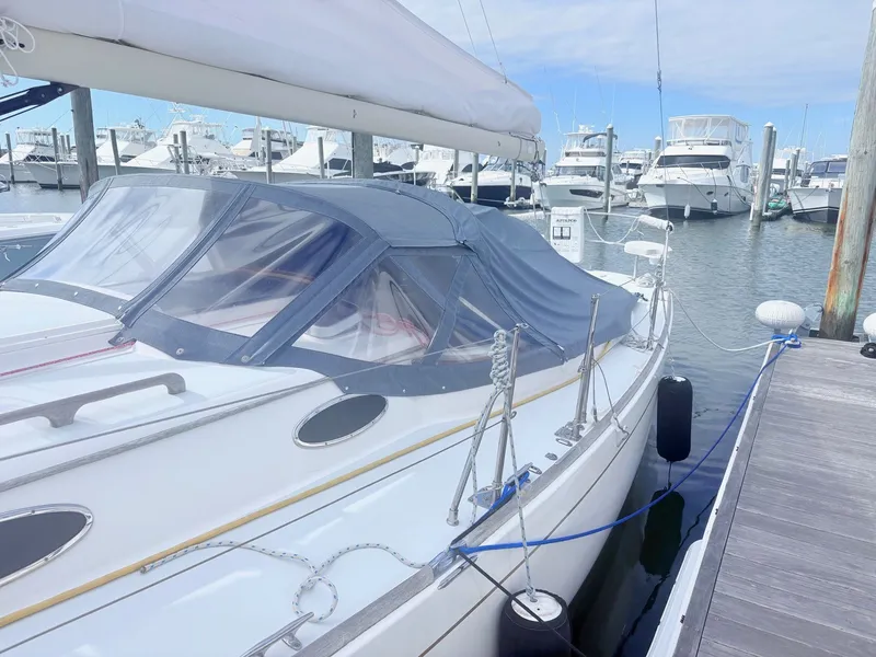 Slide: The Image of A 2009 Alerion Express 38 docked, with other boats visible in the background. - 3