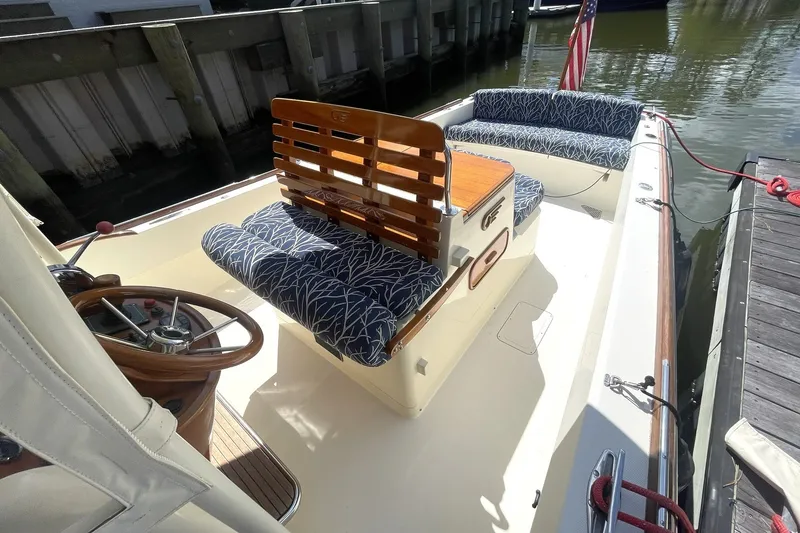 Slide: The Image of HELM SEAT & ENGINE BOX THAT IS HYDRAULIC AND HAS AN AFT FACING SEAT WITH WETBAR & STORAGE - 10