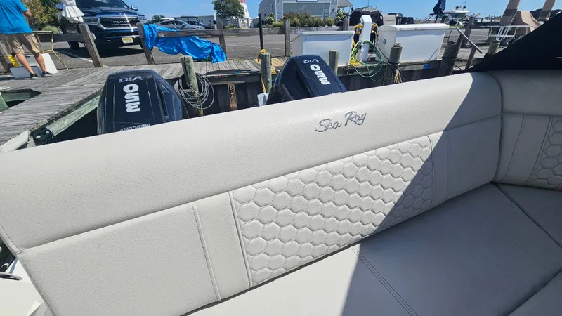 Slide: The Image of The image shows the upholstery of a Sea Ray Sundancer 320 Outboard with a stylish honeycomb pattern. - 8