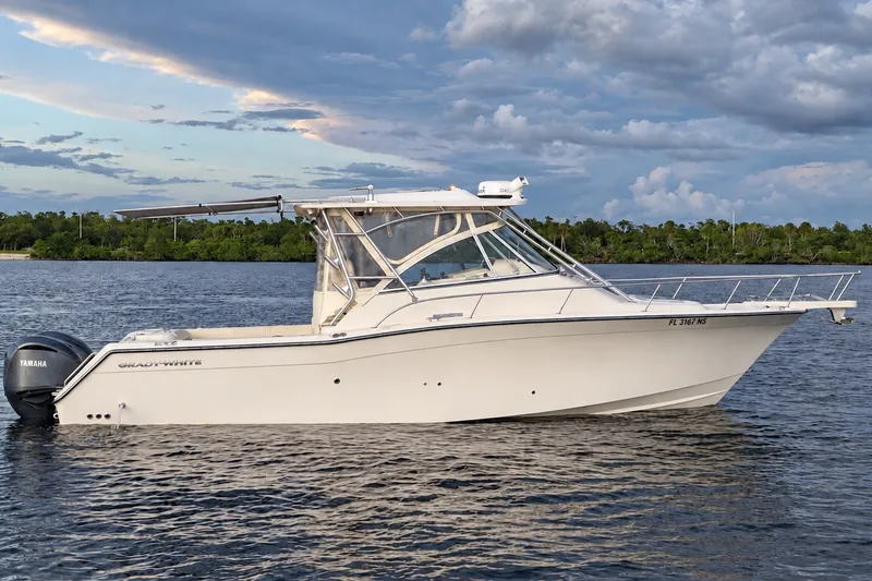 Slide: The Image of 2008 Grady-White Express 330 boat on calm water with Yamaha engines. - 5