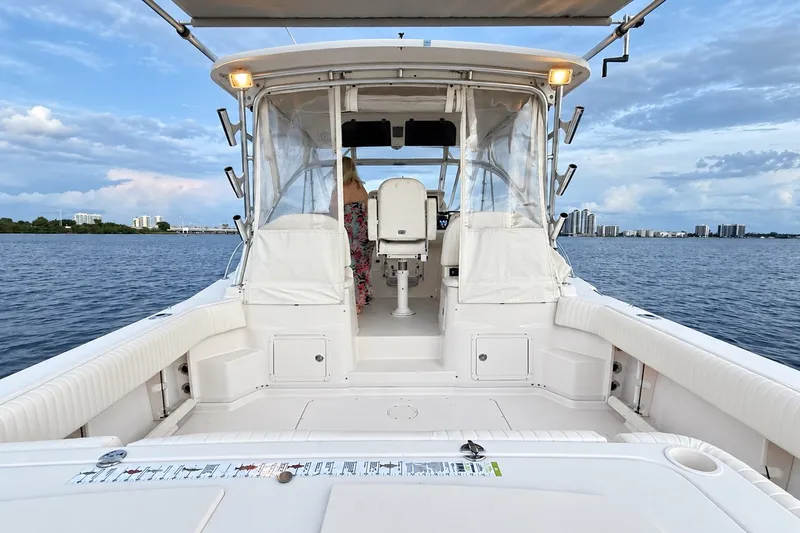 Slide: The Image of 2008 Grady-White Express 330 boat on water, featuring spacious deck and clear skies. - 18