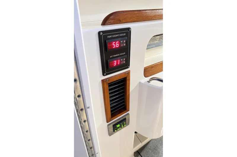 Slide: The Image of 2008 Grady-White Express 330 boat interior with digital cooler controls and wooden accents. - 25