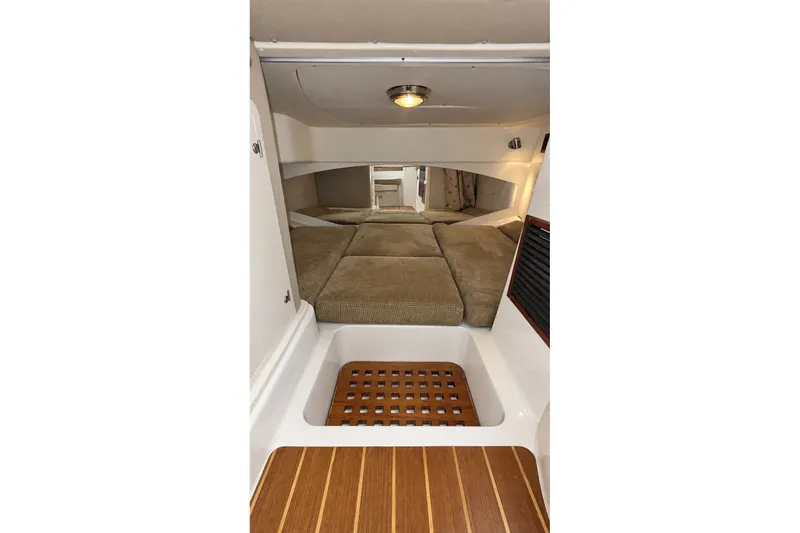Slide: The Image of 2008 Grady-White Express 330 cabin interior with cushioned seating and wooden flooring. - 43