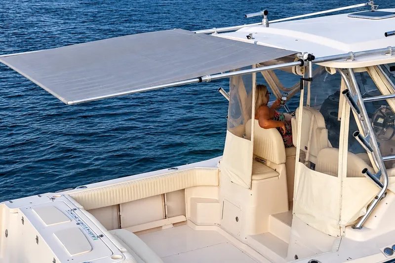 Slide: The Image of 2008 Grady-White Express 330 boat with sunshade, woman relaxing on deck. - 15