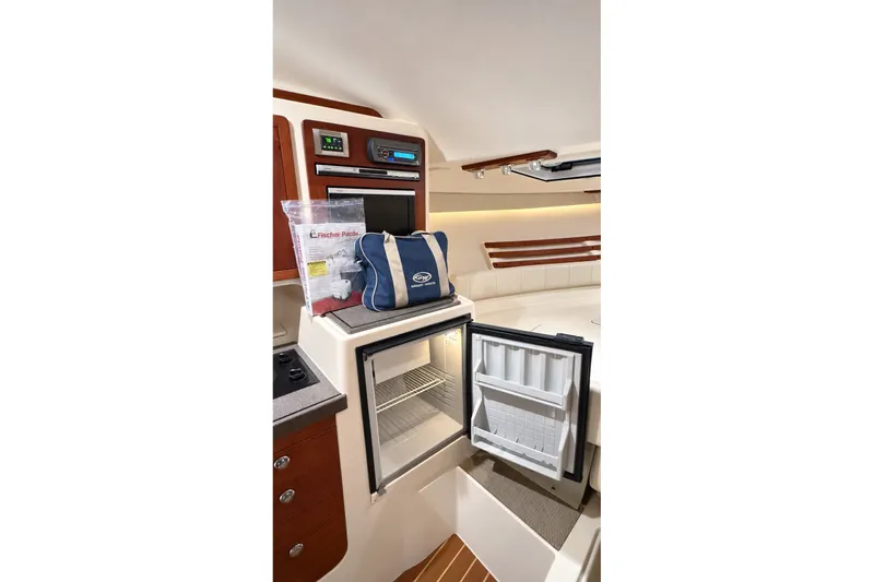 Slide: The Image of Interior of 2008 Grady-White Express 330 boat with open fridge and storage area. - 26