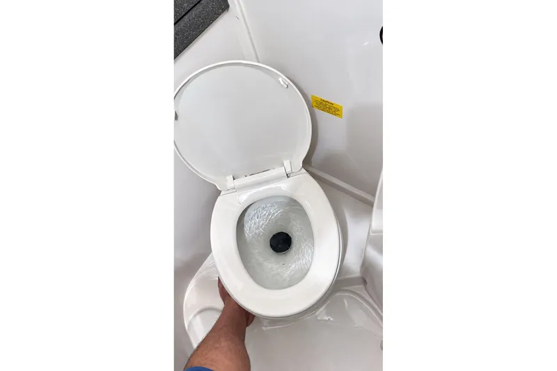 Slide: The Image of Boat toilet in 2008 Grady-White Express 330, lid open, flushing water visible. - 36