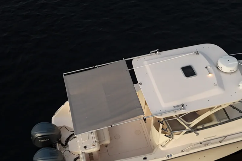 Slide: The Image of 2008 Grady-White Express 330 boat with dual Yamaha engines on calm water. - 16
