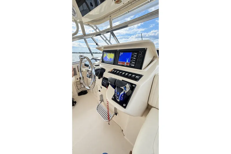 Slide: The Image of 2008 Grady-White Express 330 helm with modern navigation displays and controls. - 23