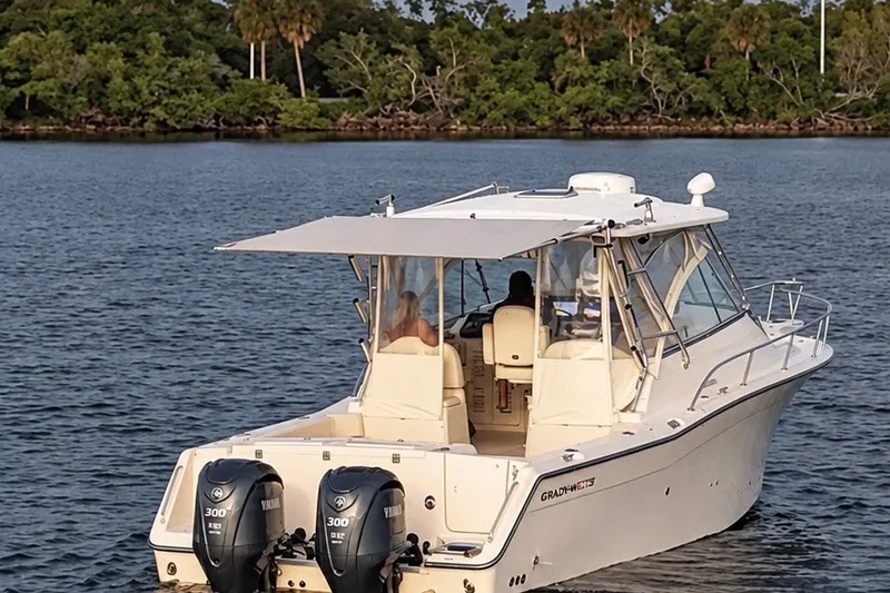 Slide: The Image of 2008 Grady-White Express 330 boat on water with twin Yamaha engines. - 10