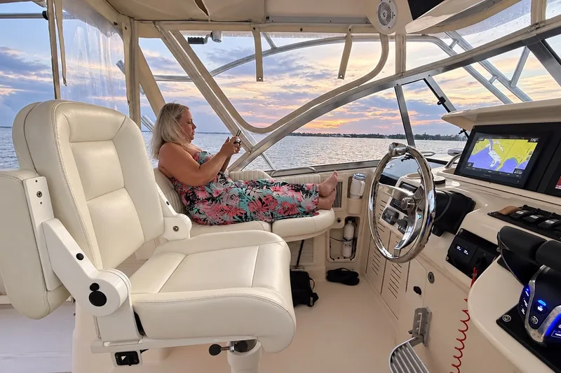 Slide: The Image of Woman relaxing on a 2008 Grady-White Express 330 boat at sunset. - 20
