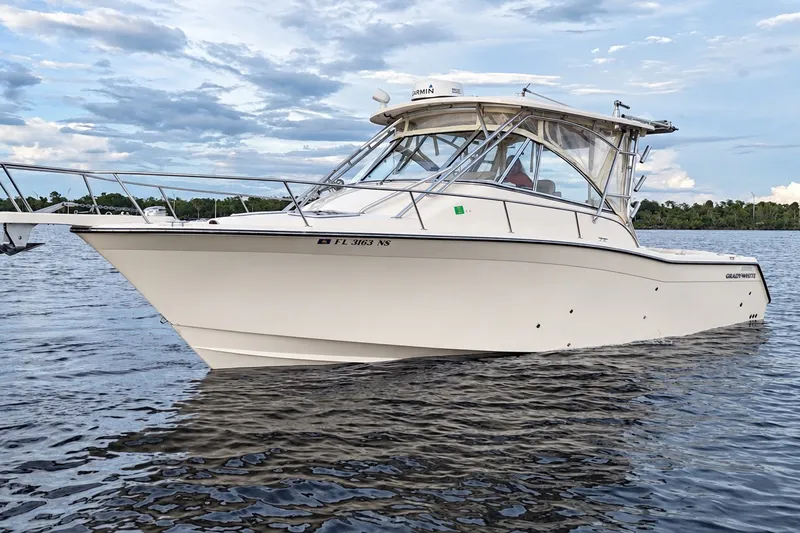 Slide: The Image of 2008 Grady-White Express 330 boat on calm water under a cloudy sky. - 13