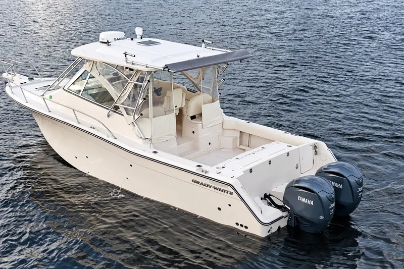Slide: The Image of 2008 Grady-White Express 330 boat with twin Yamaha engines on water. - 14