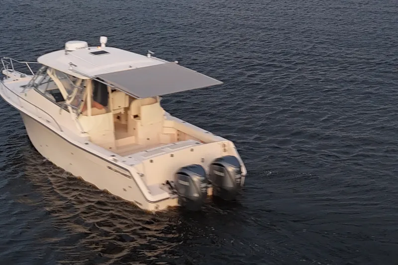 Slide: The Image of 2008 Grady-White Express 330 boat cruising on open water with twin engines. - 12