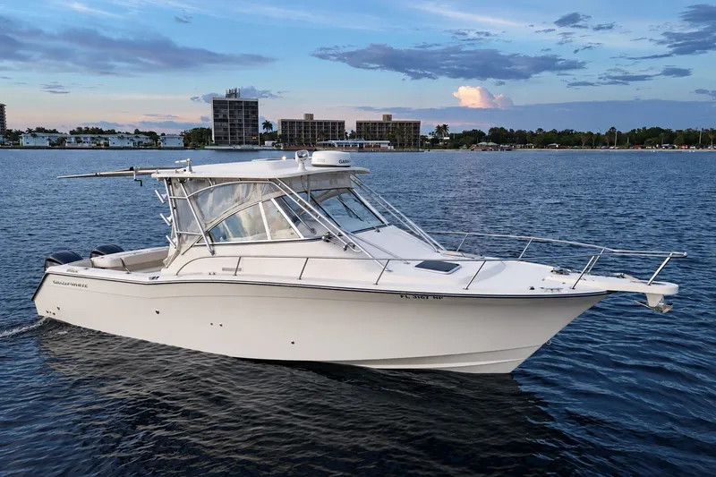 Slide: The Image of 2008 Grady-White Express 330 boat cruising on calm waters at sunset. - 6