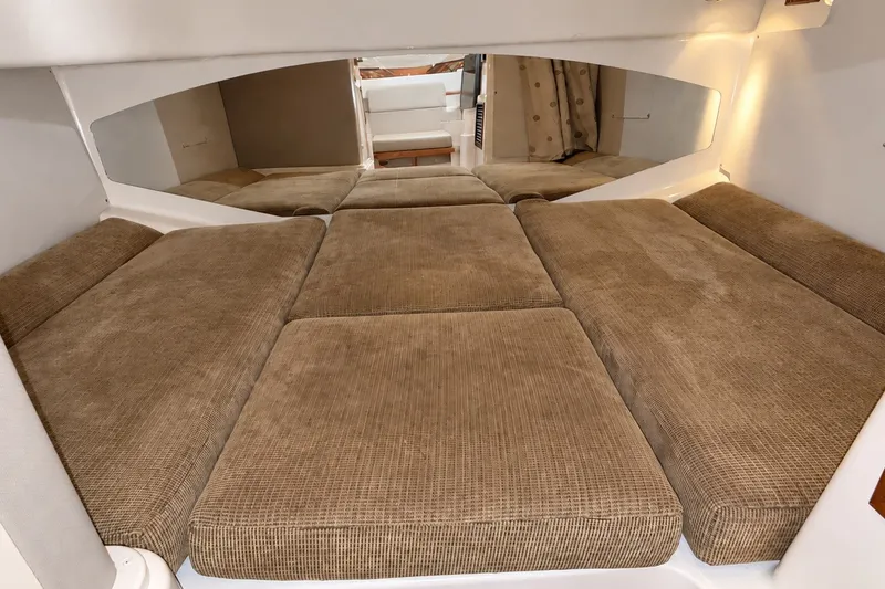 Slide: The Image of 2008 Grady-White Express 330 cabin interior with cushioned sleeping area. - 44