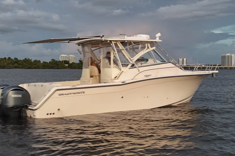 Slide: The Image of 2008 Grady-White Express 330 boat cruising on calm waters under a cloudy sky. - 9