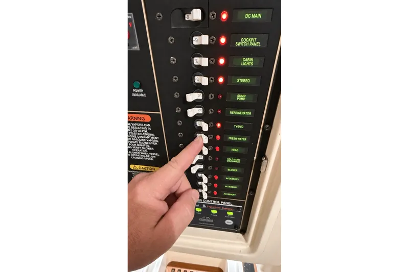 Slide: The Image of Control panel of a 2008 Grady-White Express 330 boat with switches and indicators. - 32