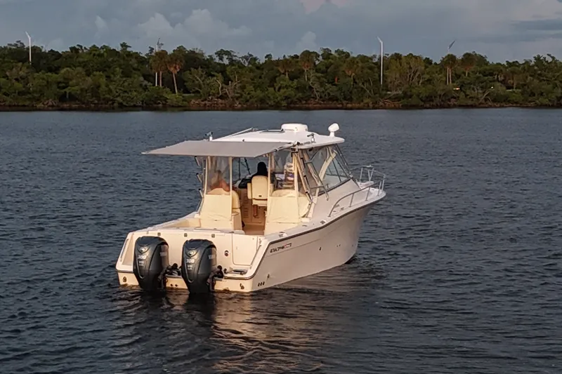Slide: The Image of 2008 Grady-White Express 330 boat on calm water, with twin engines. - 11