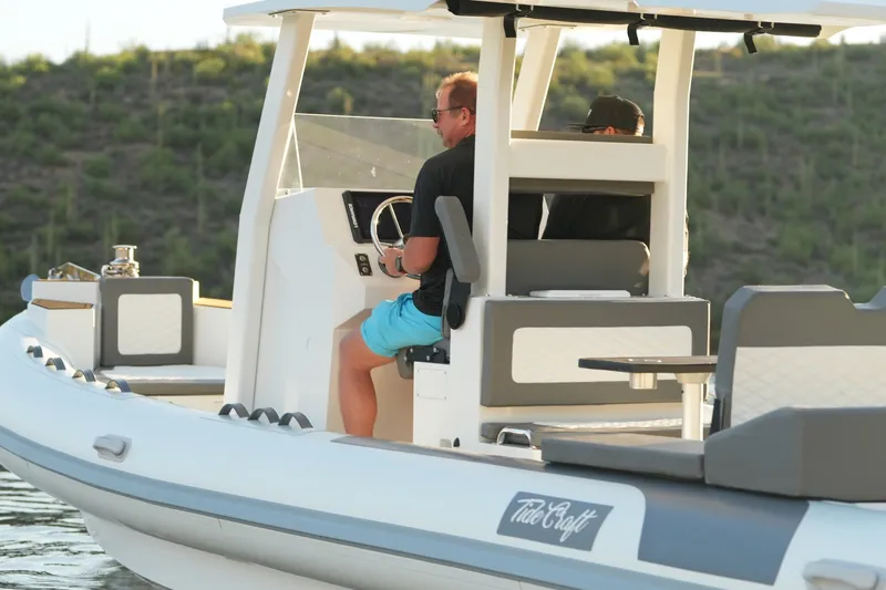 Slide: The Image of 2027 Tide Craft 26 Capri boat with two people navigating on a sunny day. - 3