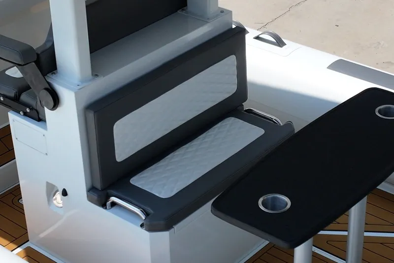 Slide: The Image of 2027 Tide Craft 26 Capri boat seating and table with cup holders. - 19