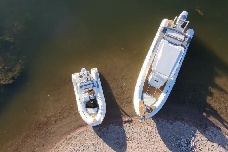 Slide: The Image of Aerial view of two boats, including a 2027 Tide Craft 26 Capri, on a shoreline. - 6
