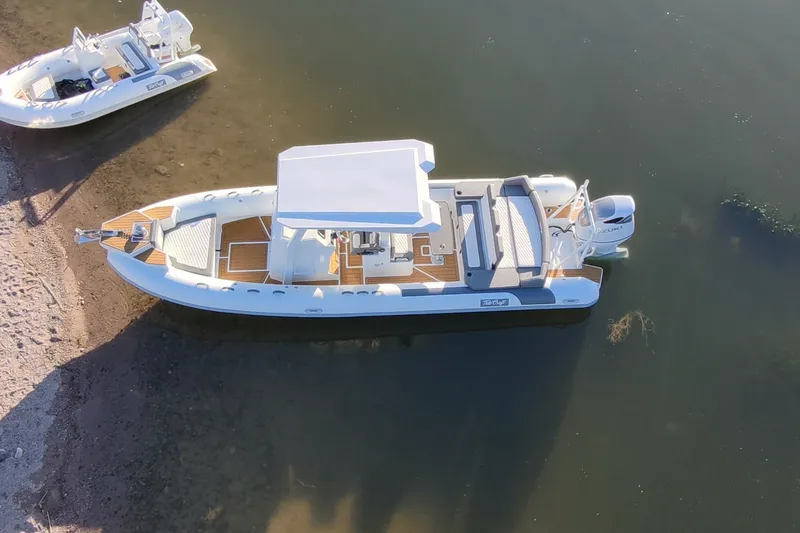 Slide: The Image of Aerial view of 2027 Tide Craft 26 Capri boat docked on calm water. - 4
