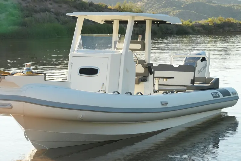 Slide: The Image of 2027 Tide Craft 26 Capri boat on calm water, featuring sleek design and modern amenities. - 10
